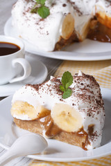 Piece of banana cake Banoffee on a white plate vertical