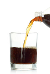 Cola pouring into glass on white background .