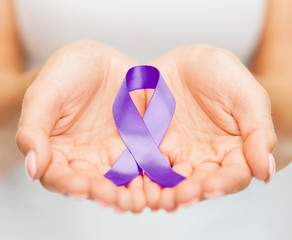 hands holding purple awareness ribbon