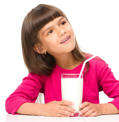 Cute little girl with a glass of milk