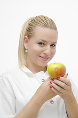 Smiley female doctor holding apple in her arms