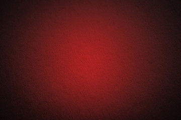 red cardboard texture or background with dark vignette borders