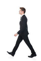 Side View Of Confident Businessman Walking