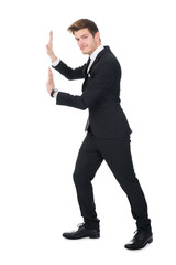 Businessman Pushing Invisible Wall