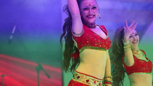 Artist girl dancing on stage in a red national Indian suit