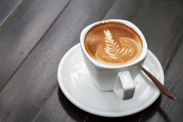 A cup of coffee latte on wooden