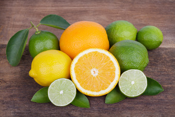 Fototapeta na wymiar Mix of fresh citrus fruits in basket on wood