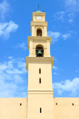 Fototapeta na wymiar View from street to bell tower of monastery saint Peter