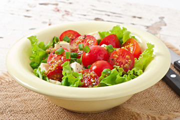 Tomato salad with lettuce, cheese and mustard and garlic dressin