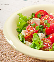 Tomato salad with lettuce, cheese and mustard and garlic dressin