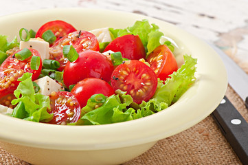 Tomato salad with lettuce, cheese and mustard and garlic dressin