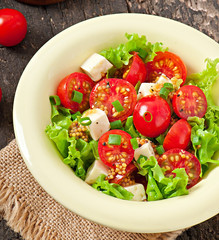 Tomato salad with lettuce, cheese and mustard and garlic dressin