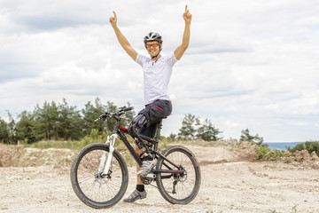 Handicapped mountain bike raising up arms