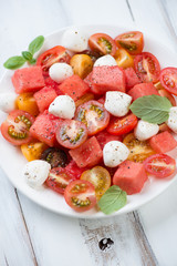 Close-up of watermelon, various tomatoes and mozzarella salad