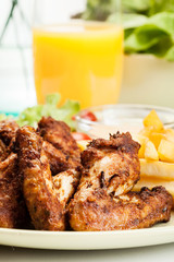 Chicken wings with fries french and spicy sauce