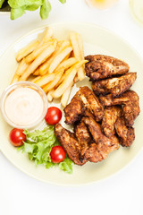 Chicken wings with fries french and spicy sauce