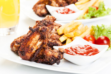 Chicken wings with fries french and spicy sauce