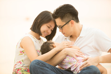 Fototapeta premium Asian family at outdoor sand beach