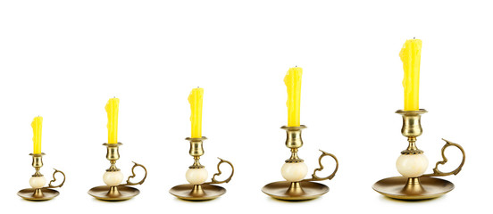 Evolution concept.Old candle holders with candle isolated