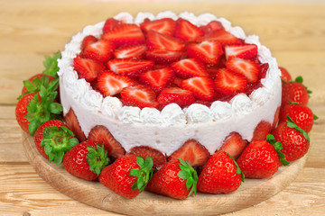 Yogurt cake with strawberries on wooden table