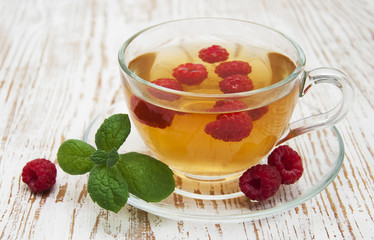 Cup of tea with raspberry