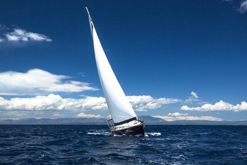 Fototapeta na wymiar Yachting. Sailing in the wind through the waves.