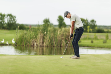 Fototapeta premium Young man playing golf