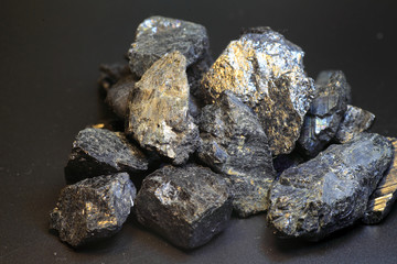 Black tourmaline an aquamarine crystal in front of black 