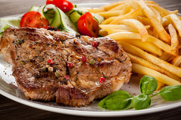 Grilled steak, French fries and vegetables
