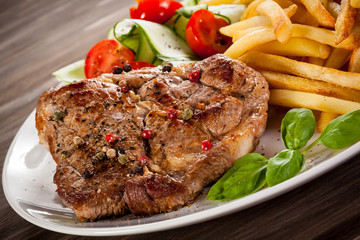 Grilled steak, French fries and vegetables