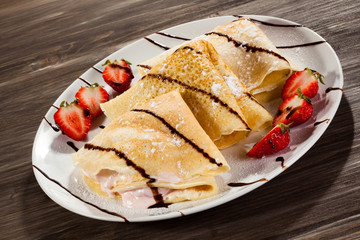 Pancakes with cream and strawberries