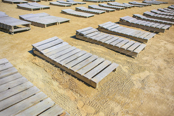 wooden plank beds on sandy coast