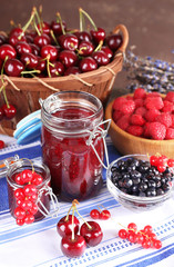 Berries jam in glass jar on table, close-up
