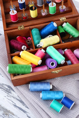 Fototapeta na wymiar Colorful threads for needlework in wooden box close up