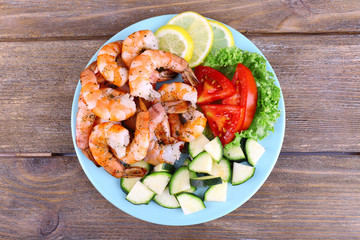 Plate of fresh boiled prawns with tomatoes, lettuce, lemon and