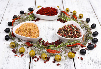 Spices in glass round bowls with herbs and chilly pepper