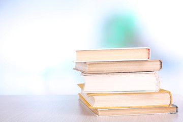 Books on wooden table on natural background
