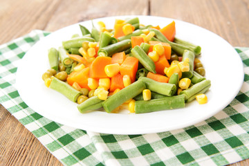 Delicious vegetables salad on plate on table close-up