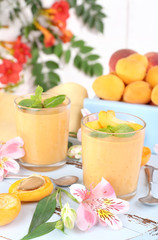 Apricot dessert in glasses on table close-up