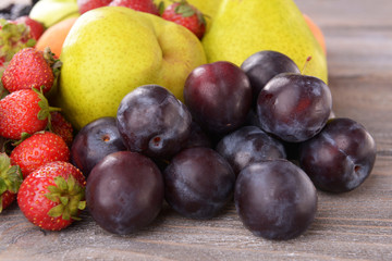 Ripe fruits and strawberries on table close up