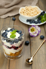 Natural yogurt with fresh berries on wooden table