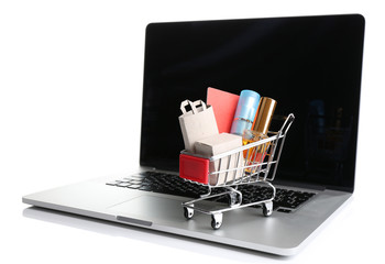 Perfume bottles, shopping bags and credit card in shopping cart