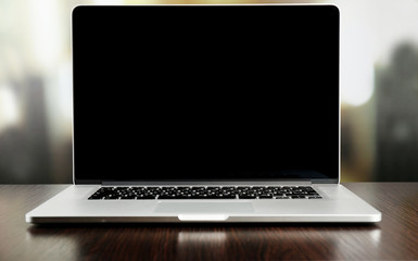 Laptop with blank screen on light background