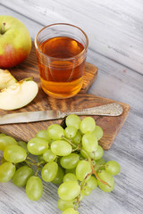 glasses of juice with fresh fruits on grey wooden table