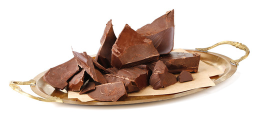 Cracked chocolate block on paper napkin isolated on white