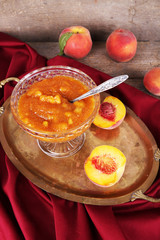 tasty apricot jam with fresh apricots on wooden table