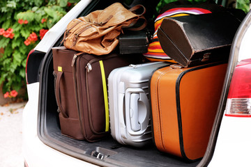 Suitcases and bags in trunk of car ready to depart for holidays