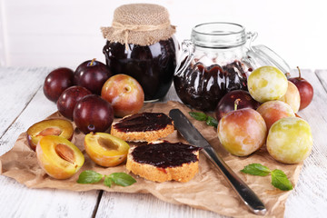Plum jam, slices of bread with plum jam and fresh plums in