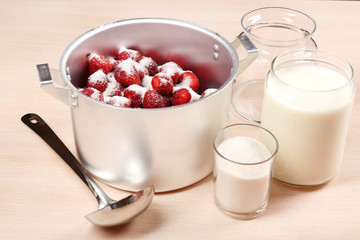 Cooking delicious strawberry jam in kitchen