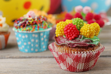Delicious birthday cupcakes on table close-up